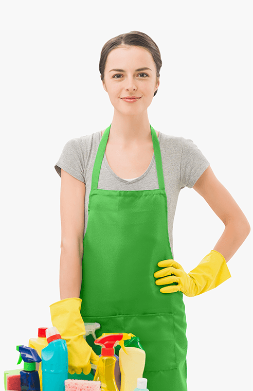 A smiling professional cleaner in a green apron holding cleaning supplies