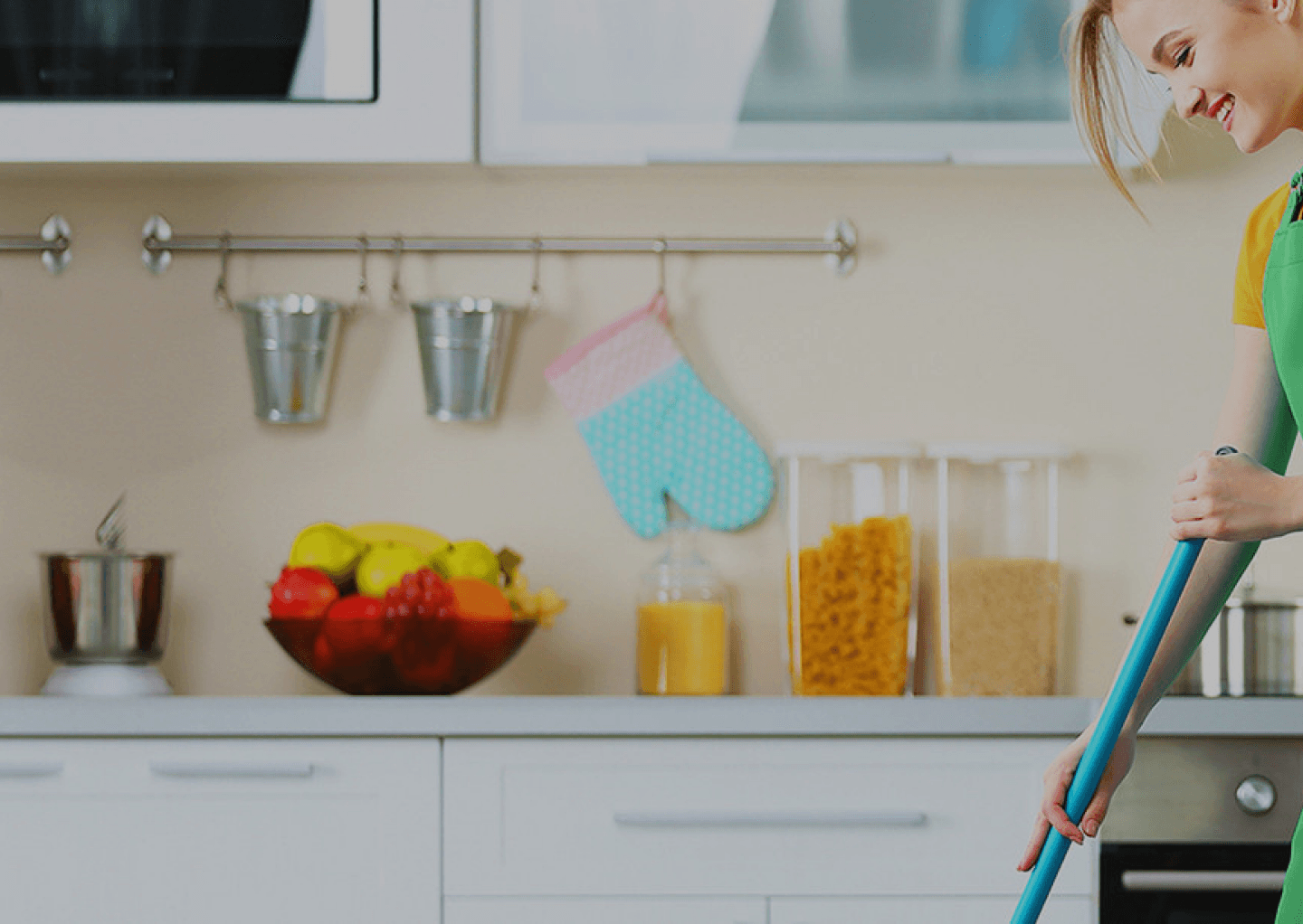Professional cleaner in a bright kitchen